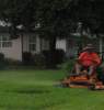Man mowing a lawn with a riding mower