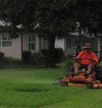 Man mowing a lawn with a riding mower