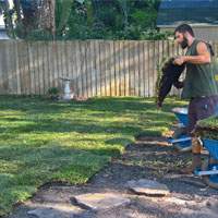 Worker planting St Augustine sod